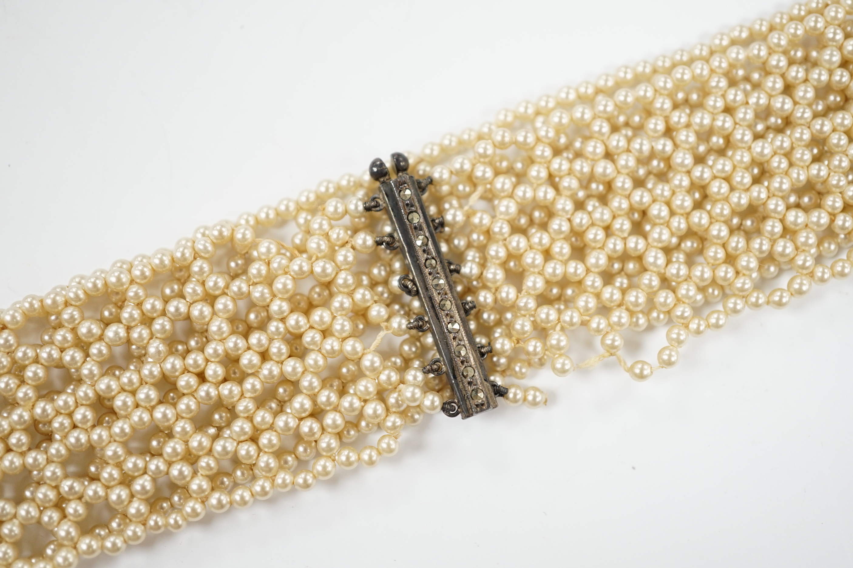 An Edwardian multi strand seed pearl set choker necklace, with marcasite set clasp, 32cm (loose pearls).